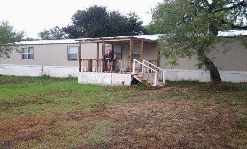 Ernest and Liza Gomez in front of their new manufactured home.