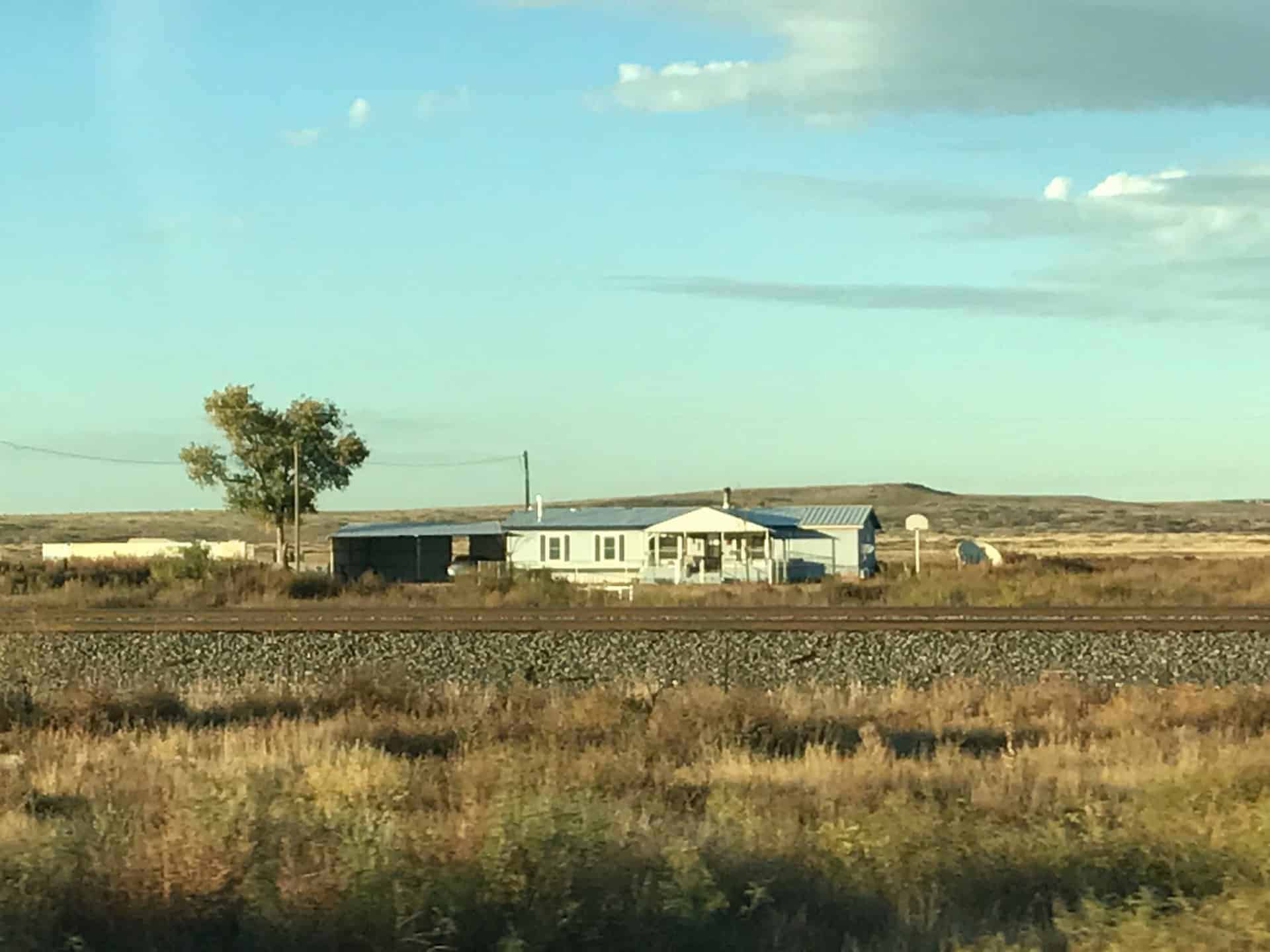 Old Mobile Home behind train tracks in a rural area