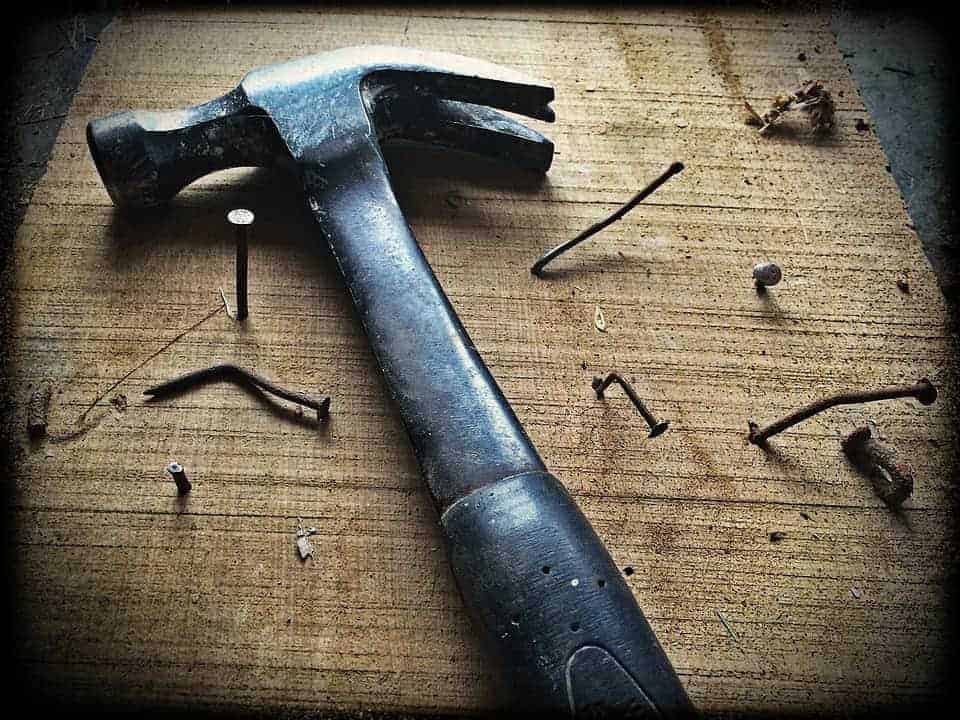 hammer and nails in and on a board