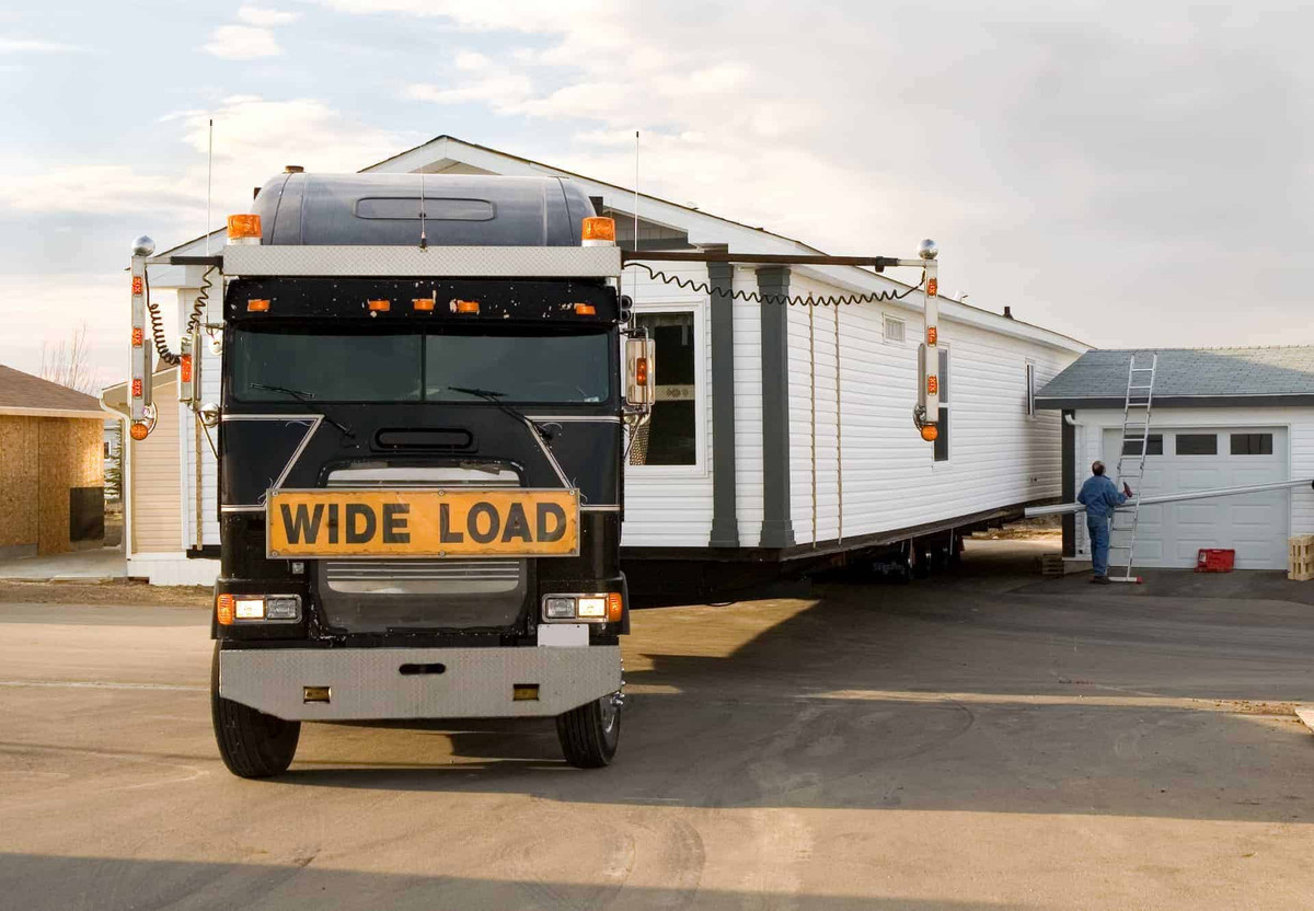 A single wide mobile home being delivered