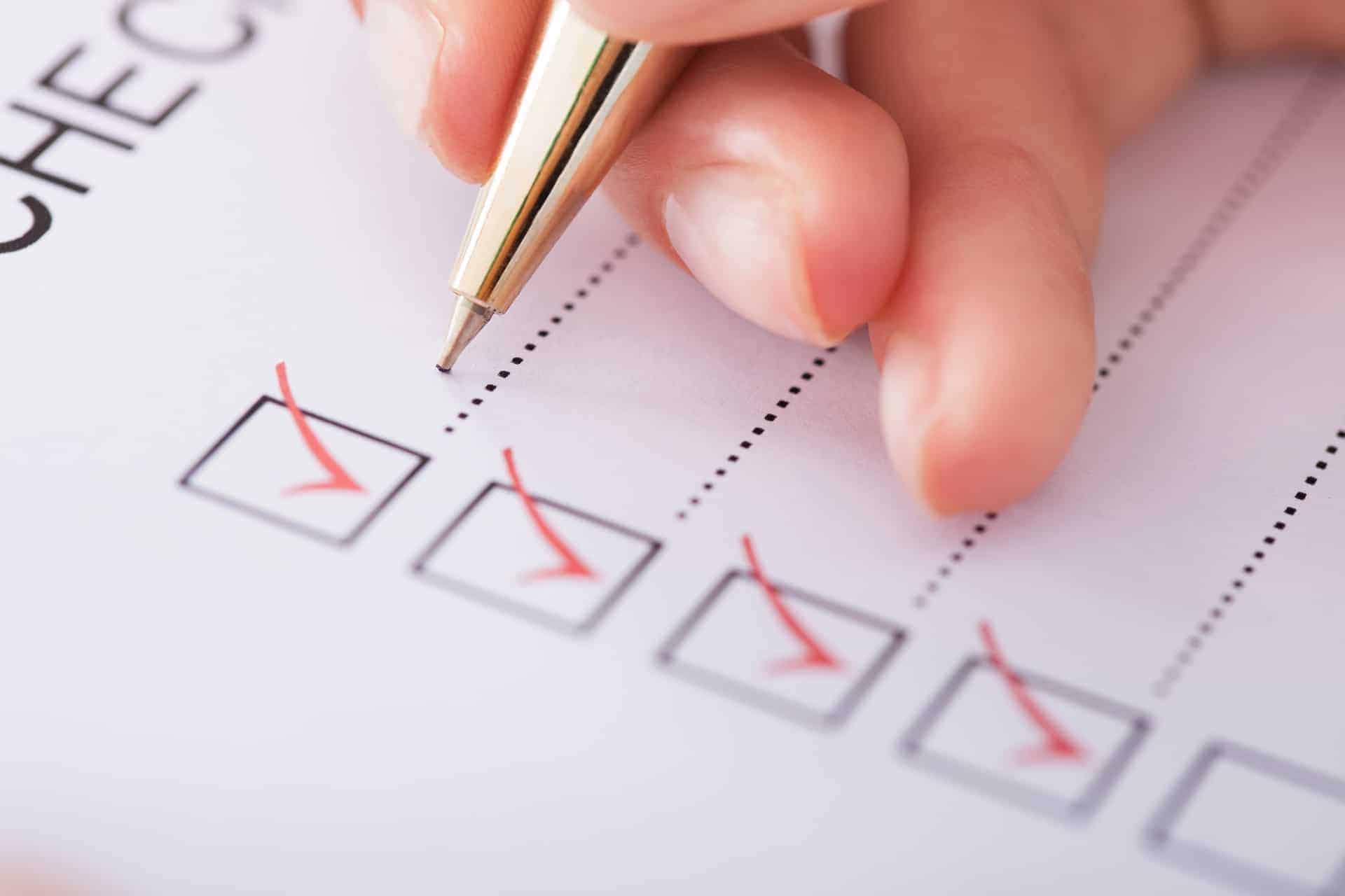 Person writing on a checklist