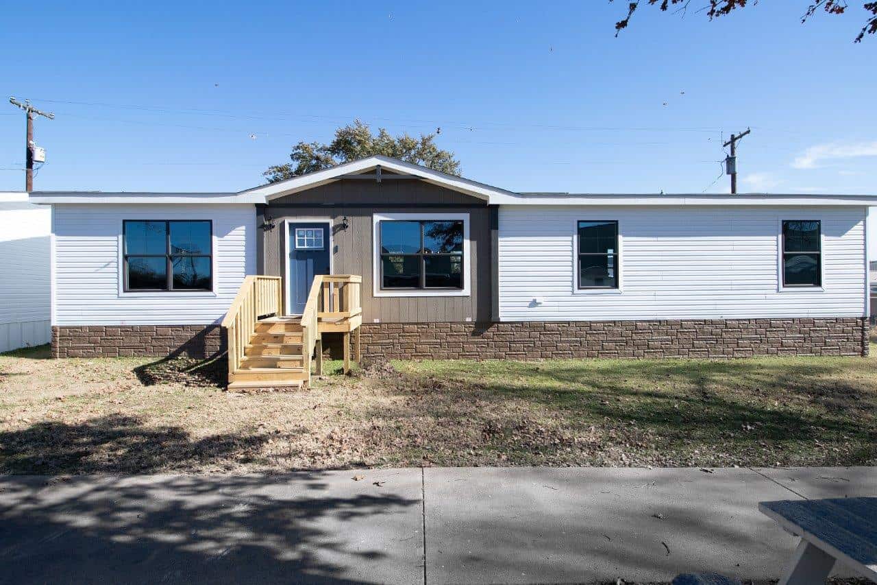 Mobile Home with wood steps leading to the Front Door