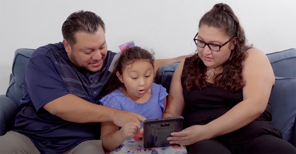 Family looking at mobile home options on tablet