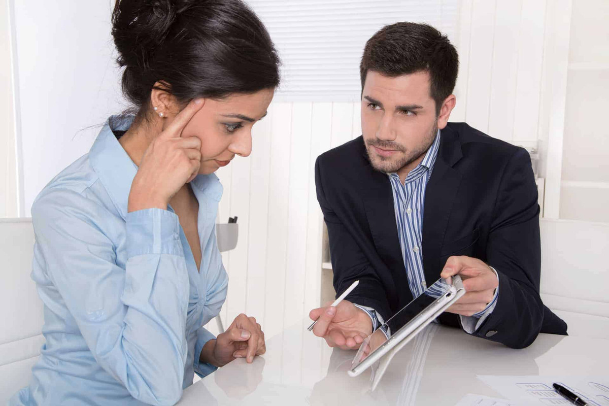 Man showing a woman something on a tablet computer