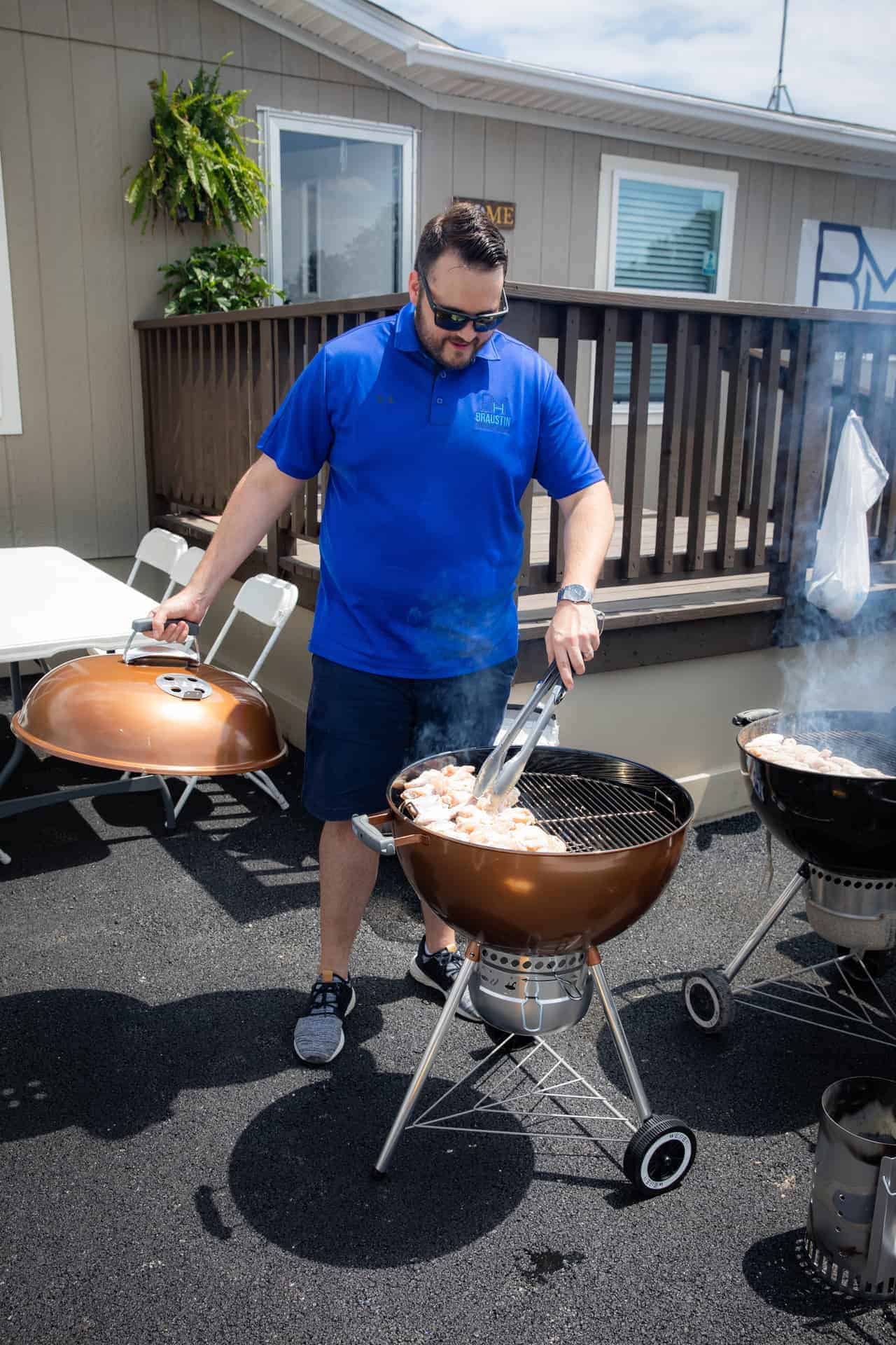 Barbecuing chicken during the Braustin Homes 2019 Dealership grand opening party