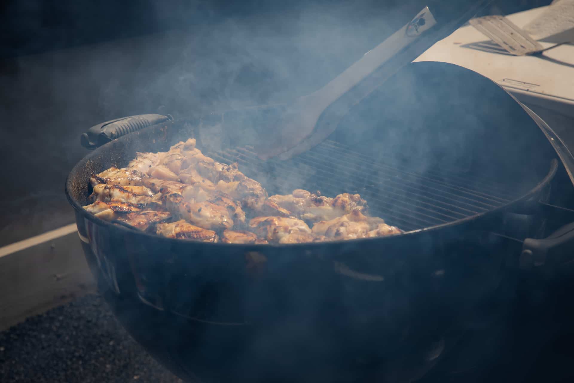 Barbecuing chicken during the Braustin Homes 2019 Dealership grand opening party