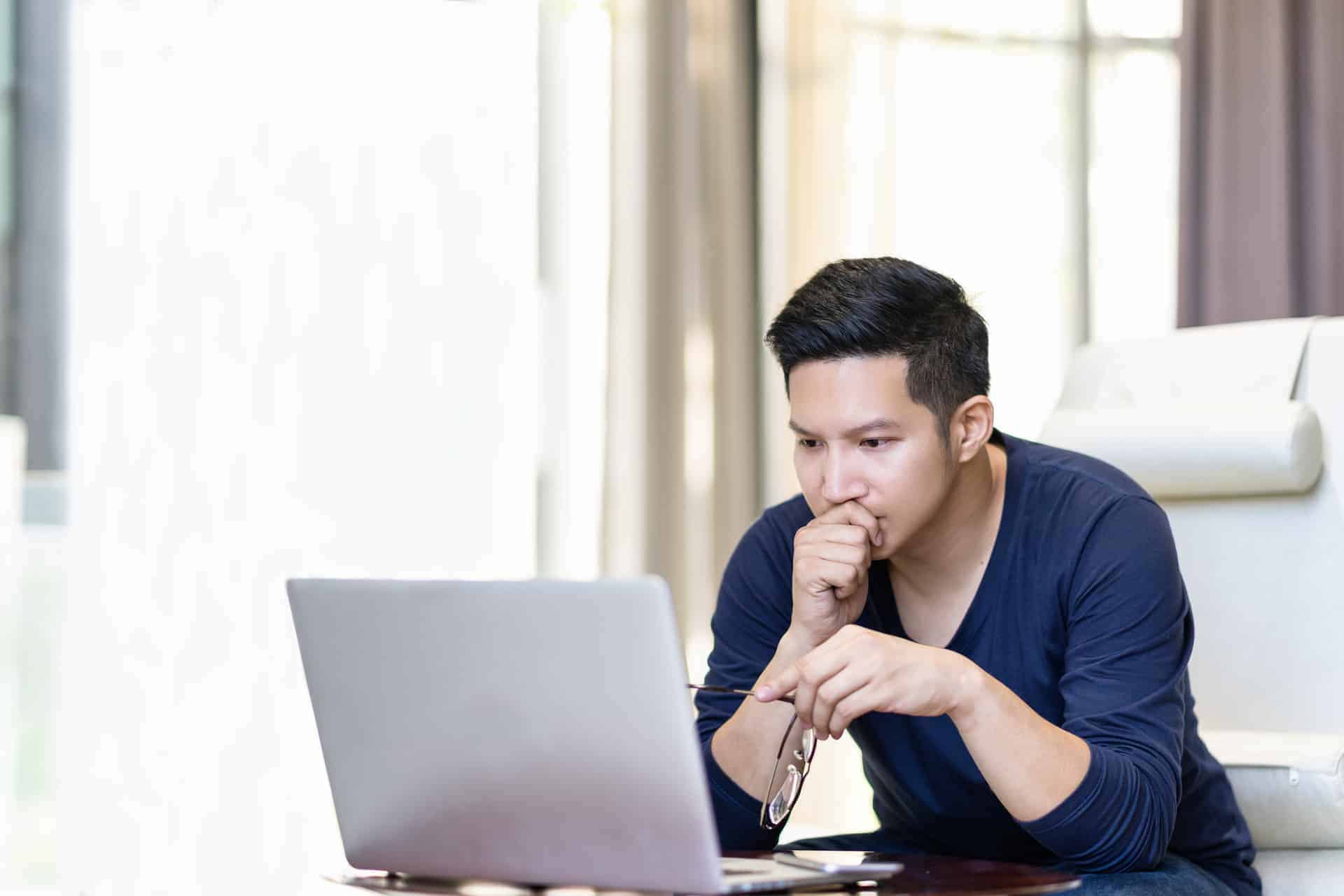 Man Intently Looking at Computer representing a person intent on improving their credit score