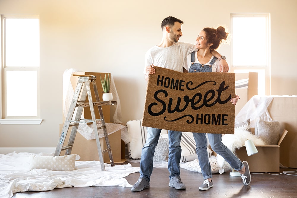 couple holding a doormat