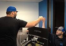 Braustin brothers in their office having fist bump